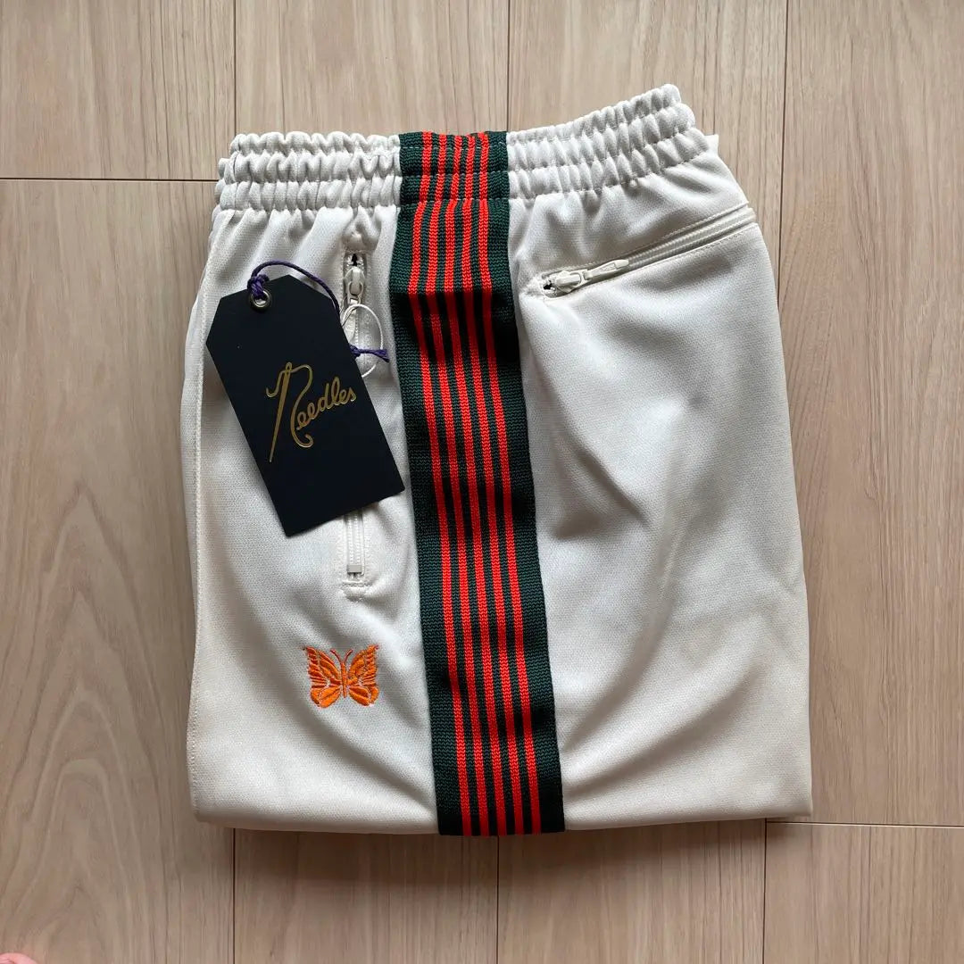 Brand new, unused needles track pants, beige, orange