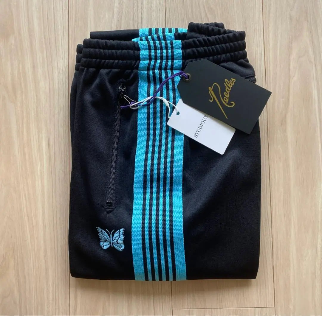 Brand new, unused needles track pants, narrow, black, turquoise