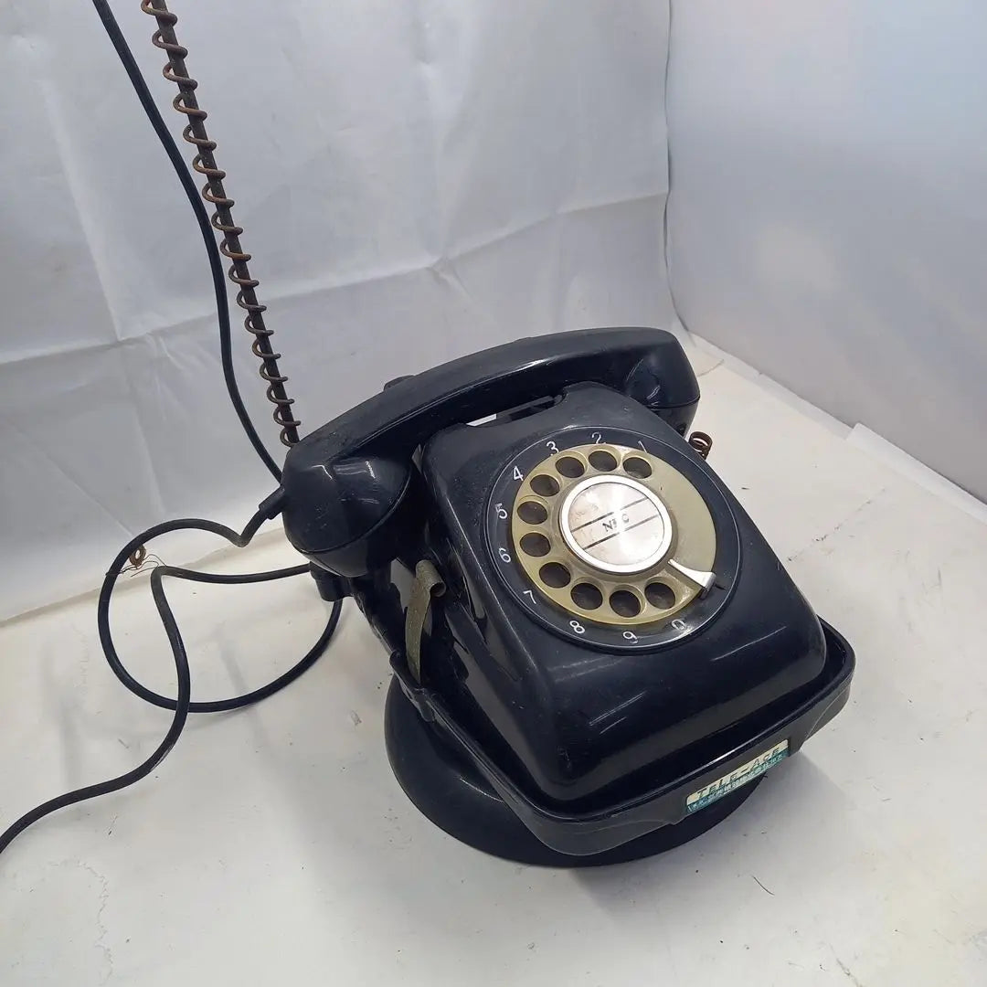 Dial type black telephone with rotating stand