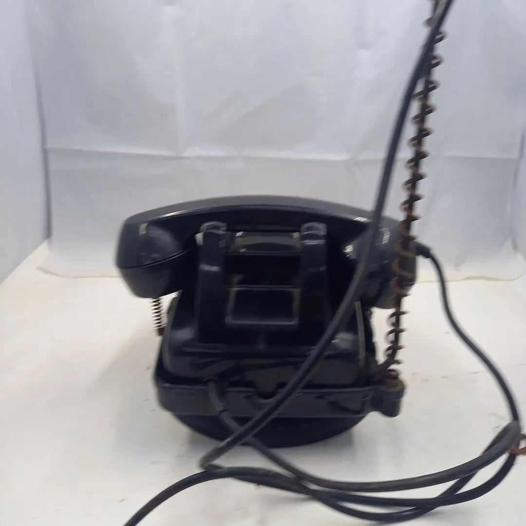 Dial type black telephone with rotating stand