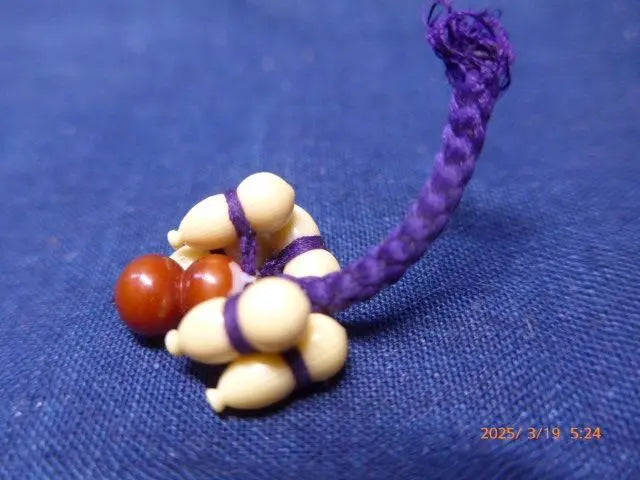 This is a keychain with a lucky gourd made from bell be rebuilt.