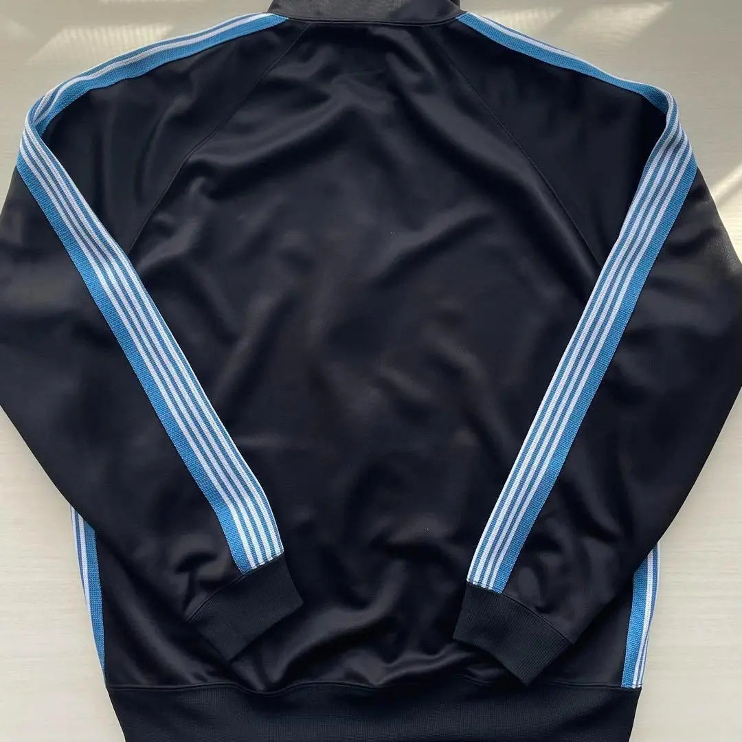 Chaqueta deportiva L Negro Azul Blanco Agujas 11