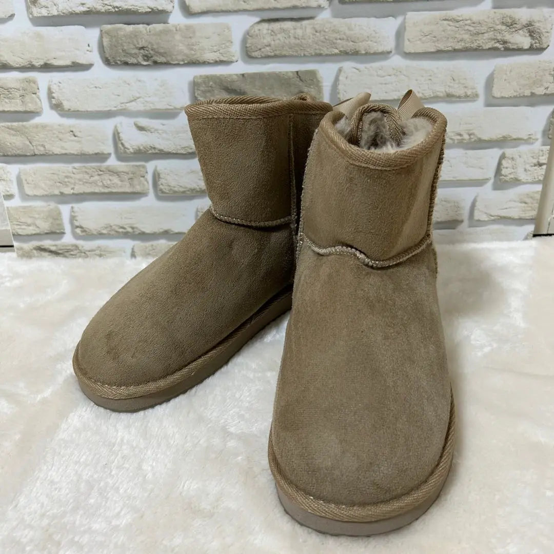 Bonitas botas de gamuza color beige con lazo en la parte posterior