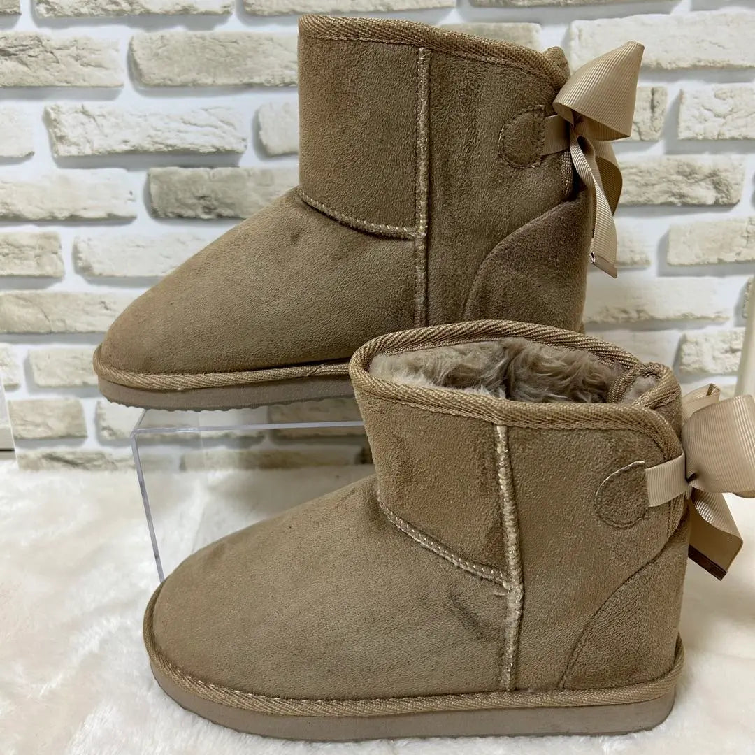 Bonitas botas de gamuza color beige con lazo en la parte posterior